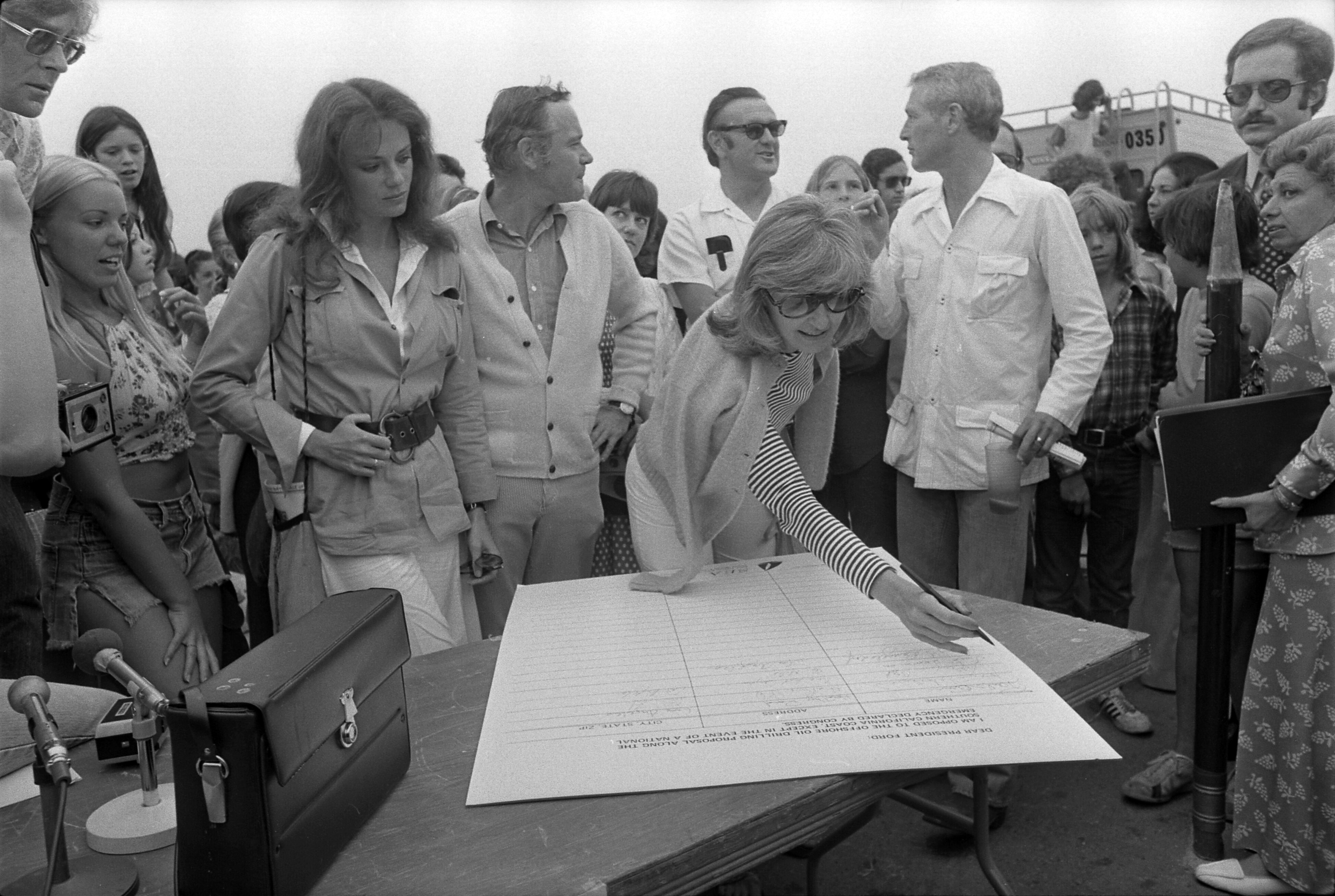 6-joanne_woodward_with_others_signing_petition_against_oil_drilling.jpg